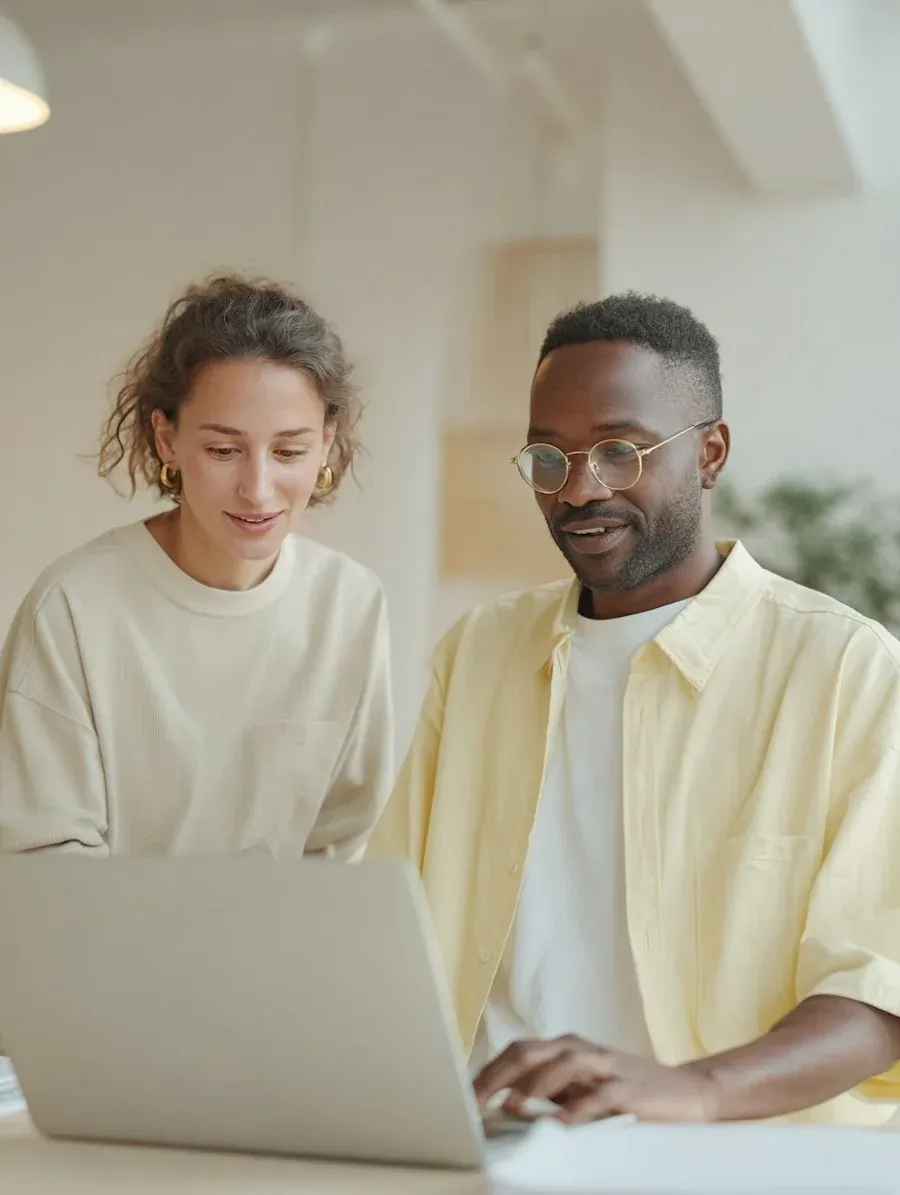 Two Liren teammates working side by side at a laptop in the early days
